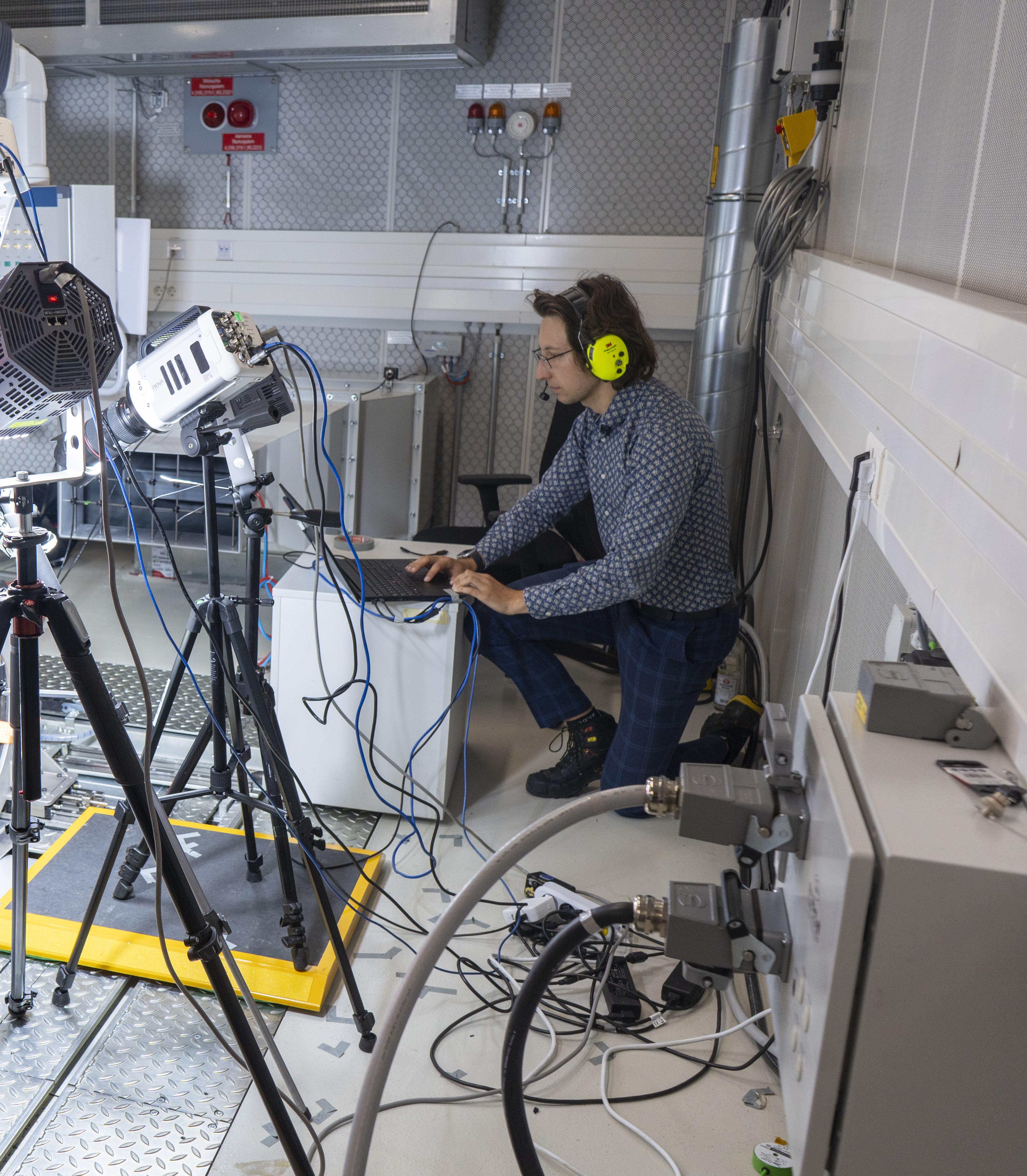 Engineer conducting experimental testing with measurement equipment in laboratory
